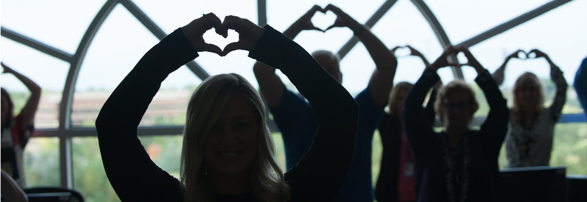 Employees standing in front of a window with hearts